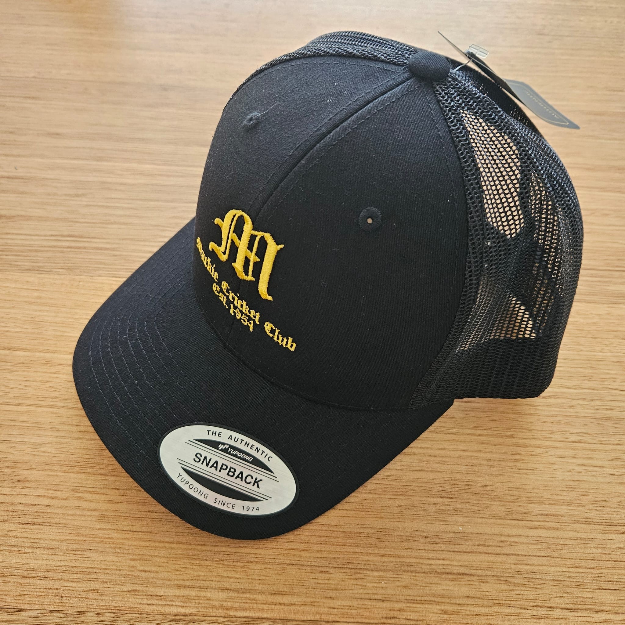 Black Mackie Cricket Club trucker cap