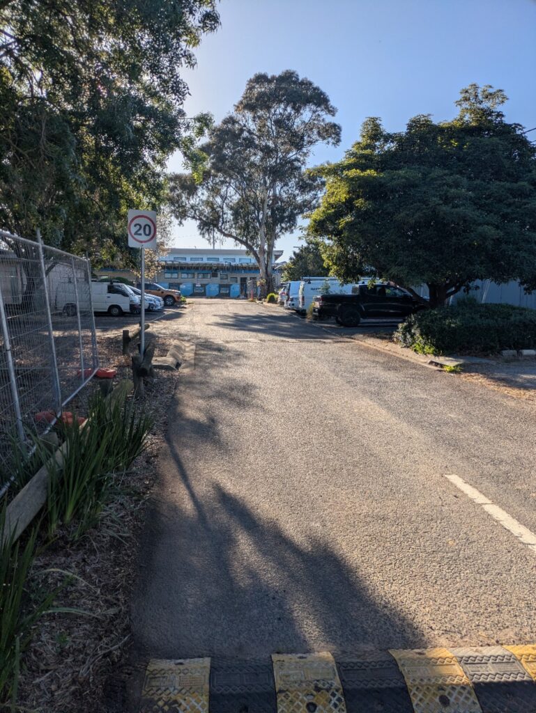 On-site parking area at Mackie Reserve with pavilion construction fencing ahead